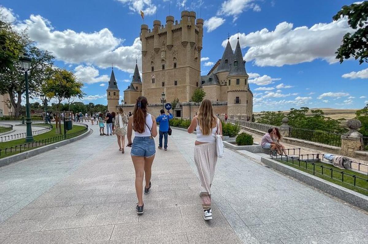 two women walking in front of a castle