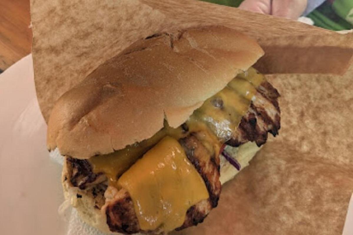 a sandwich with meat and cheese on a bun