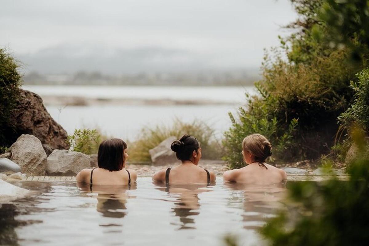 three women swimming in a body of water