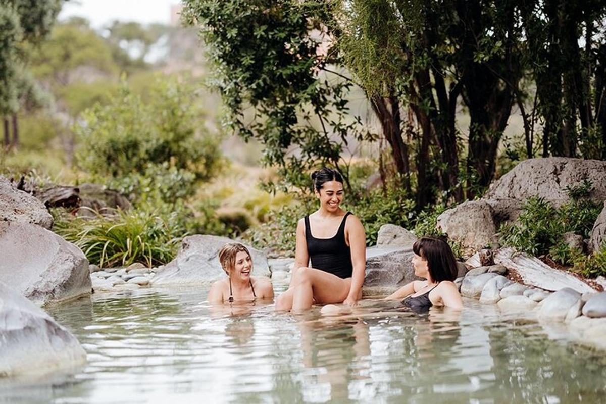 a group of three women sitting in the water