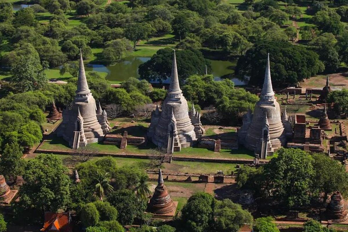 an aerial view of a temple with three white towers