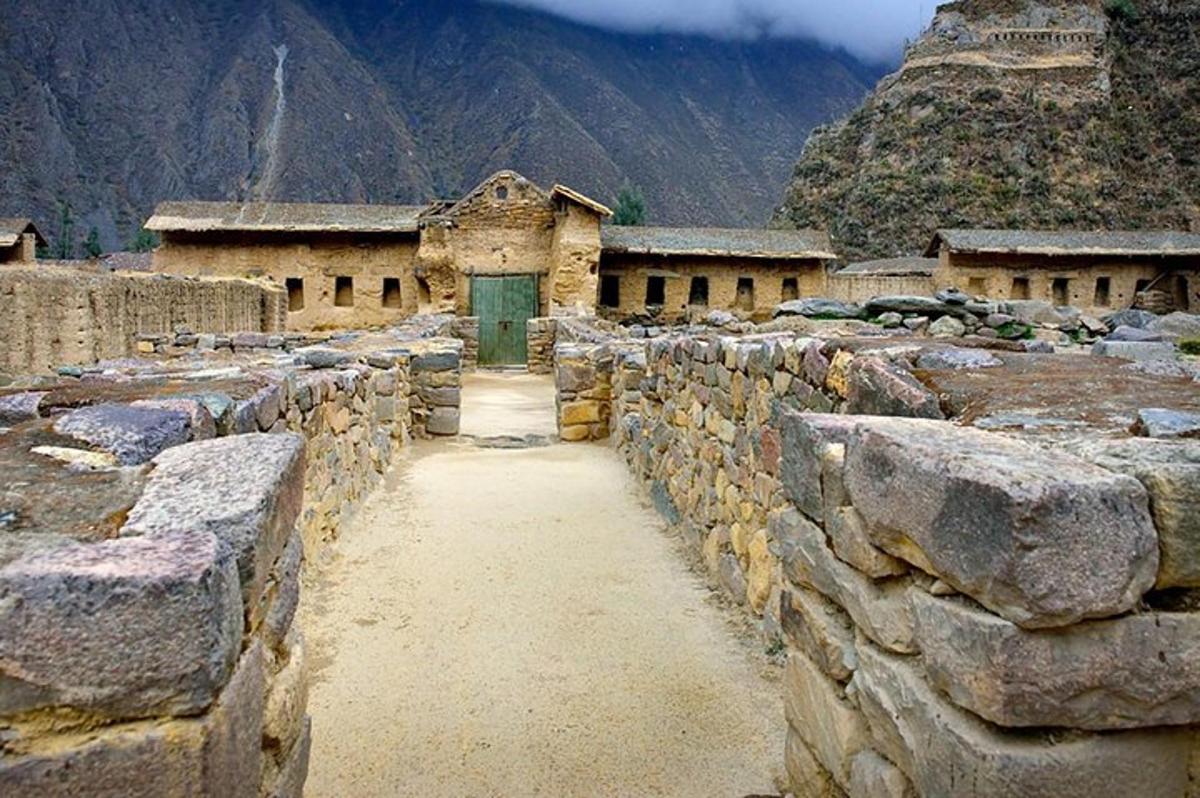 a stone building with a green door and a stone wall