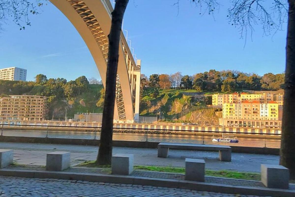 a bridge over a river with trees and buildings