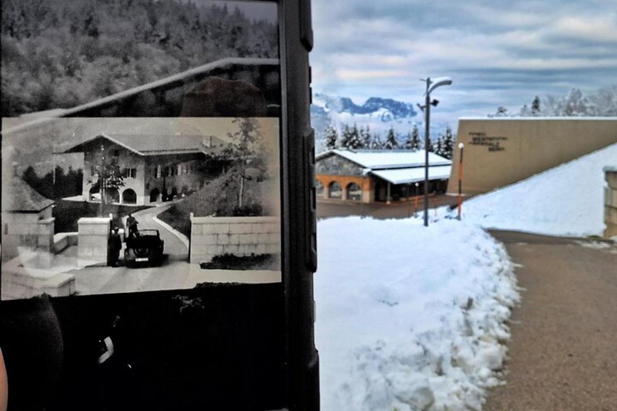 a black and white photo of a house in the snow