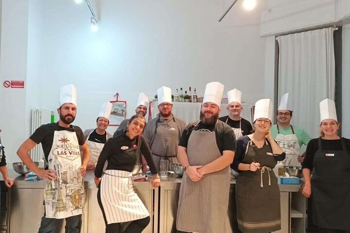 a group of chefs posing for a picture in a kitchen