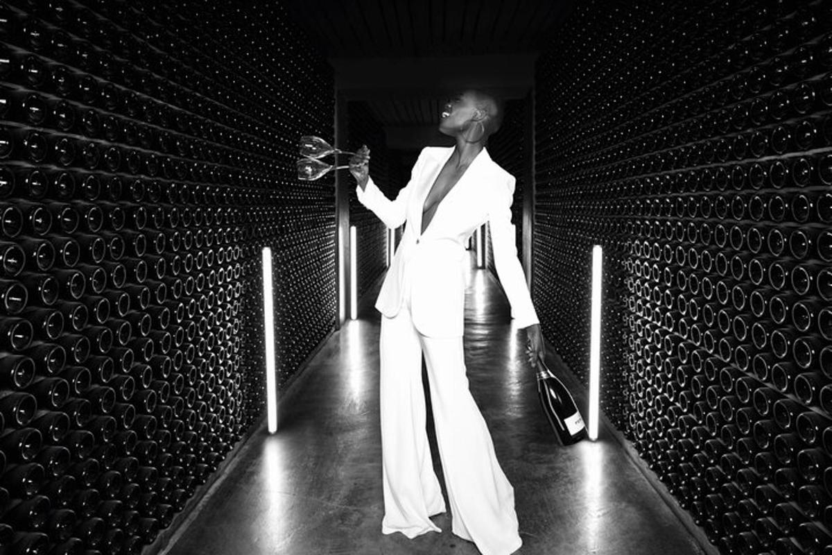 a man in a white suit standing in a room