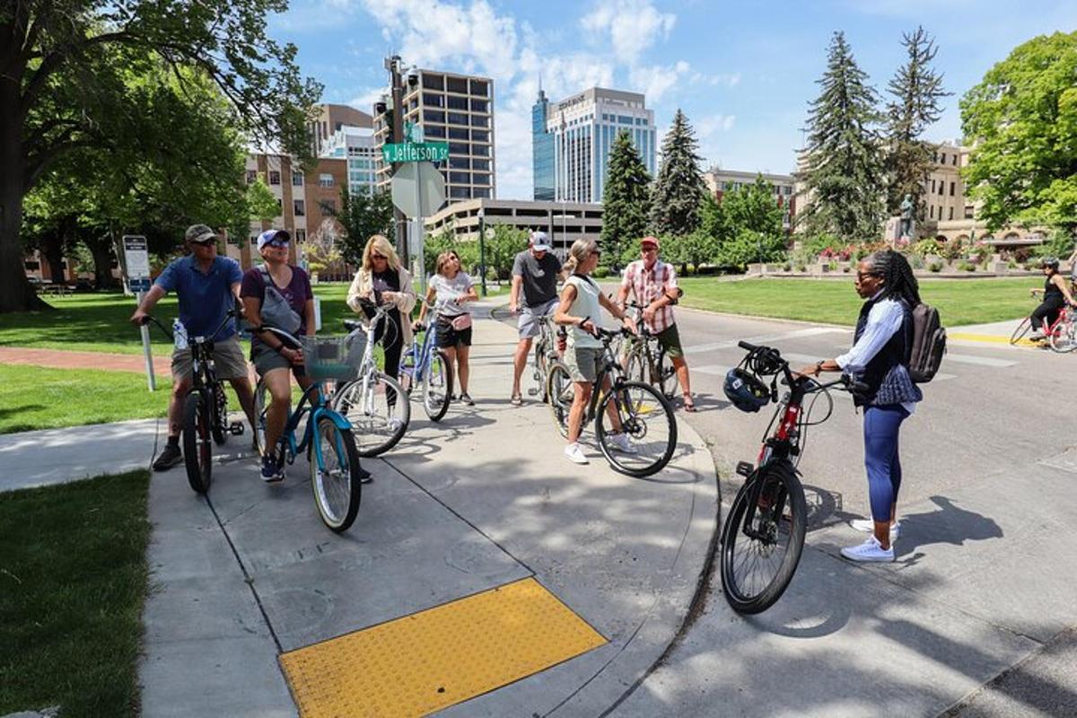 a group of people riding bikes on a sidewalk