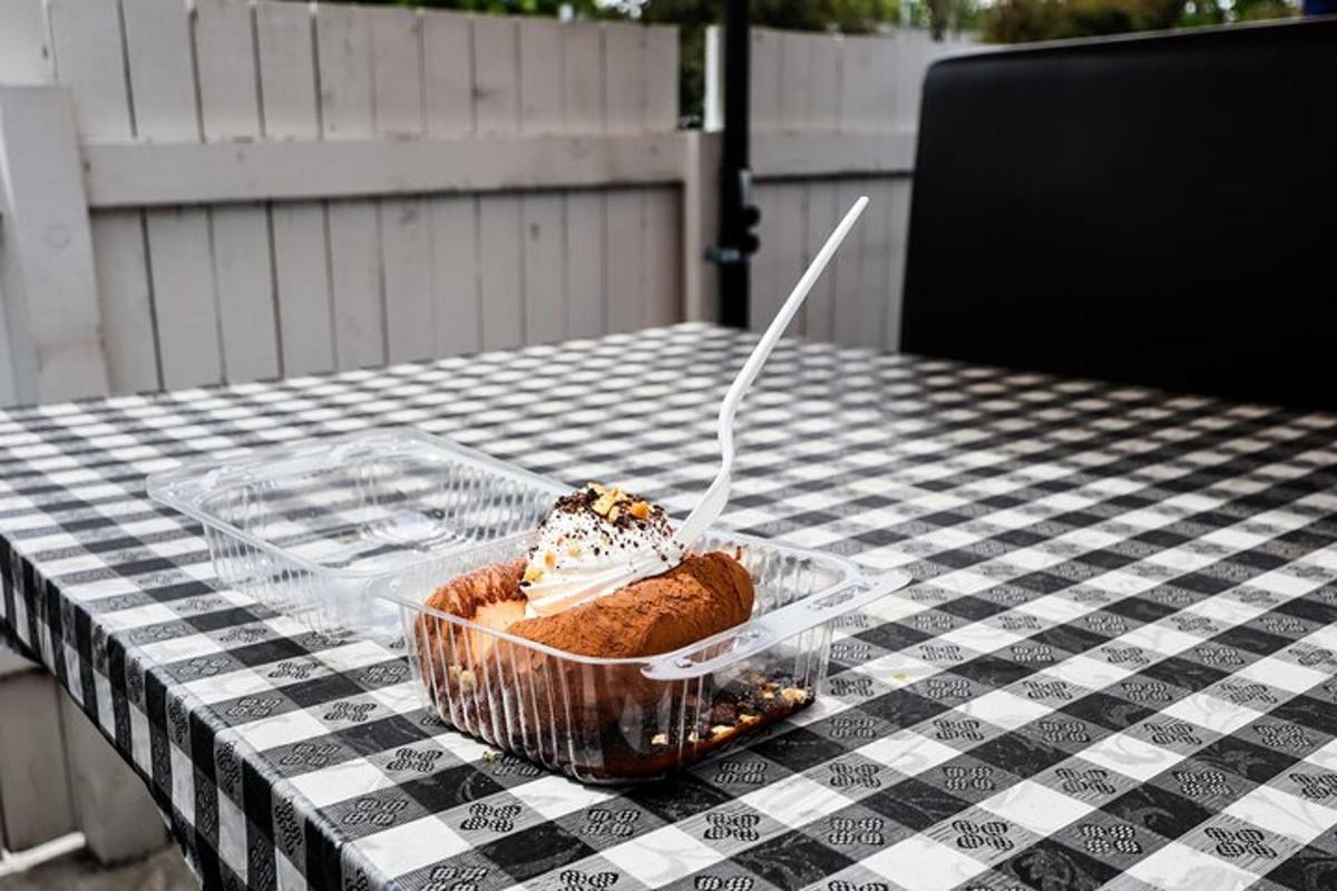 a plastic container with a dessert on a table