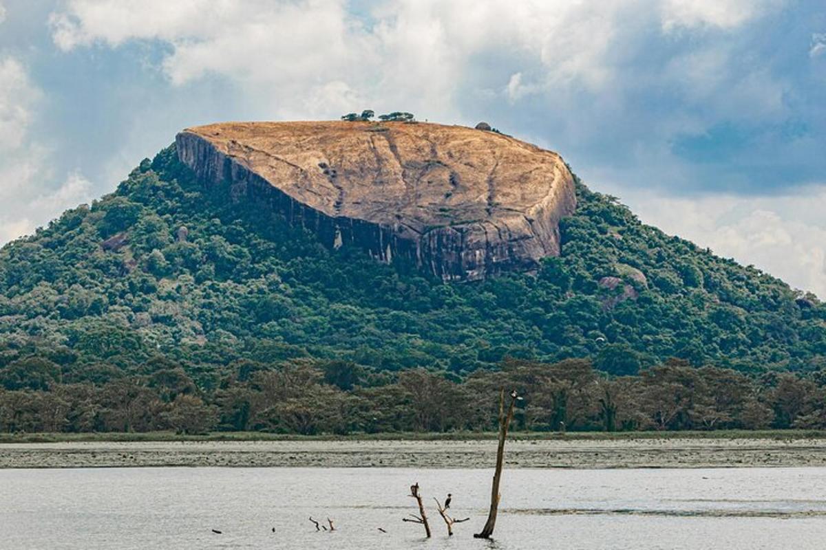 a large rock in the middle of a body of water
