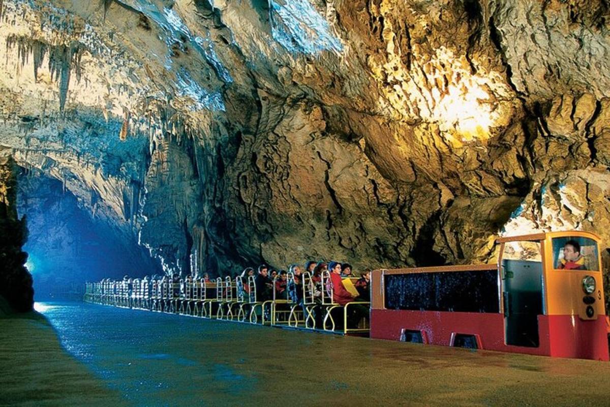 a group of people standing inside of a cave