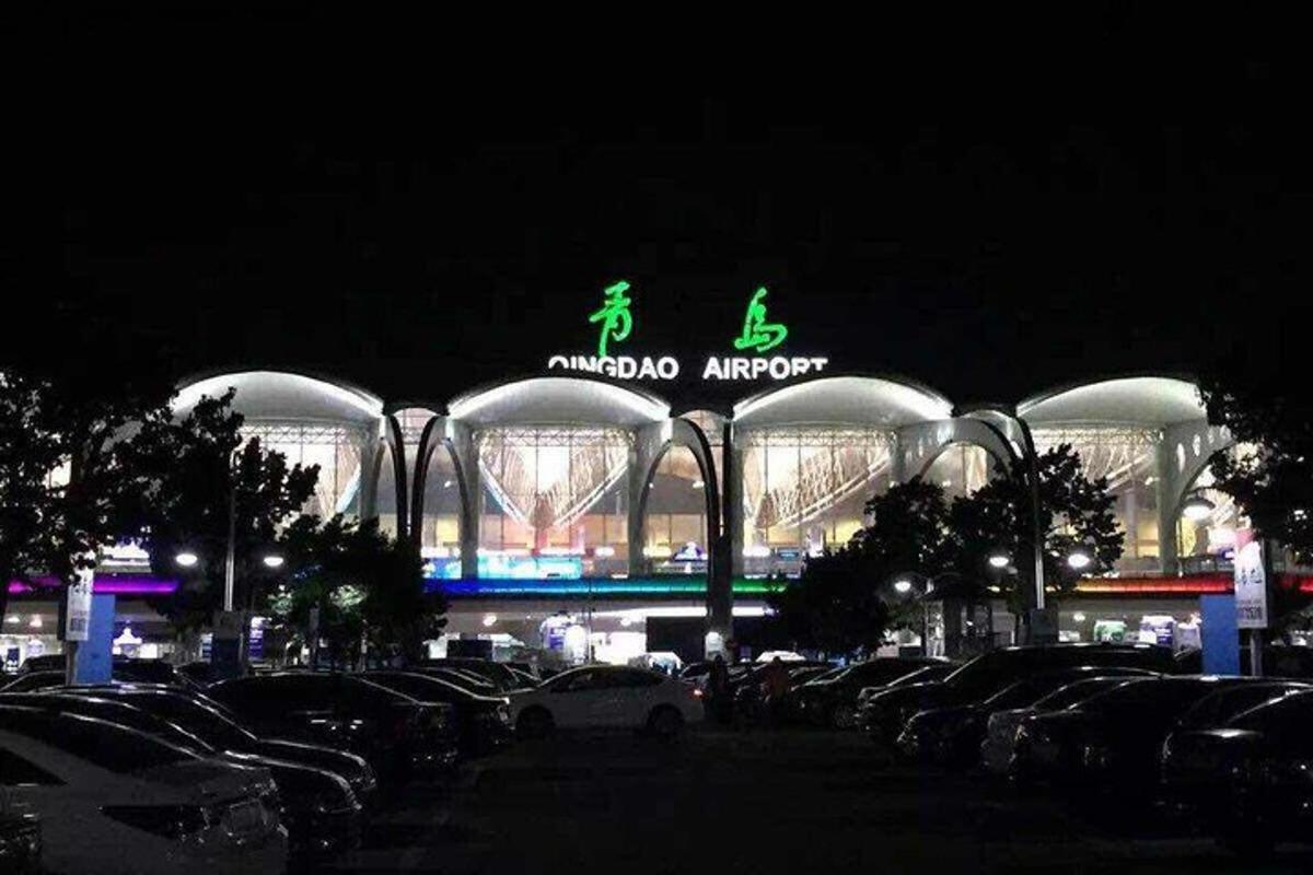 a building with cars parked in front of a parking lot