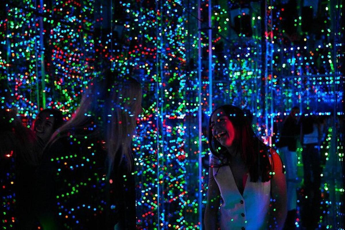 a woman standing in front of a display of christmas lights