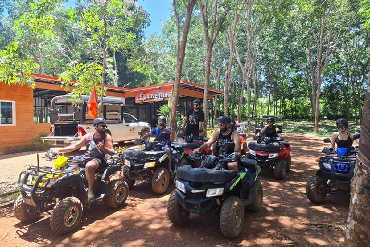 a group of people sitting on atvs in the dirt