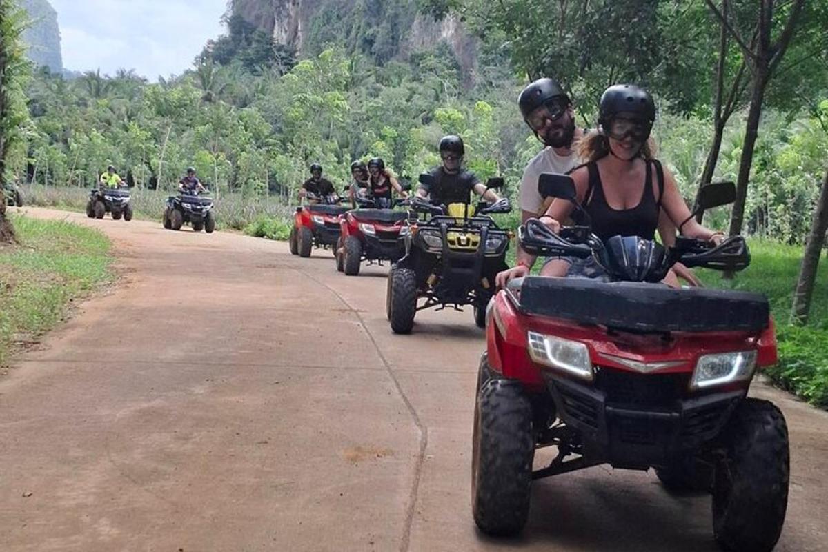 a group of people riding atvs down a dirt road