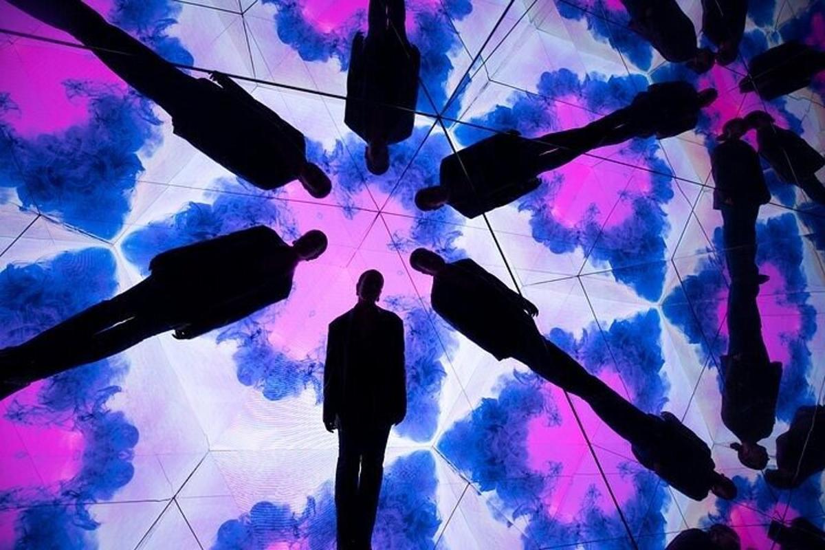 a man standing in front of a wall of umbrellas