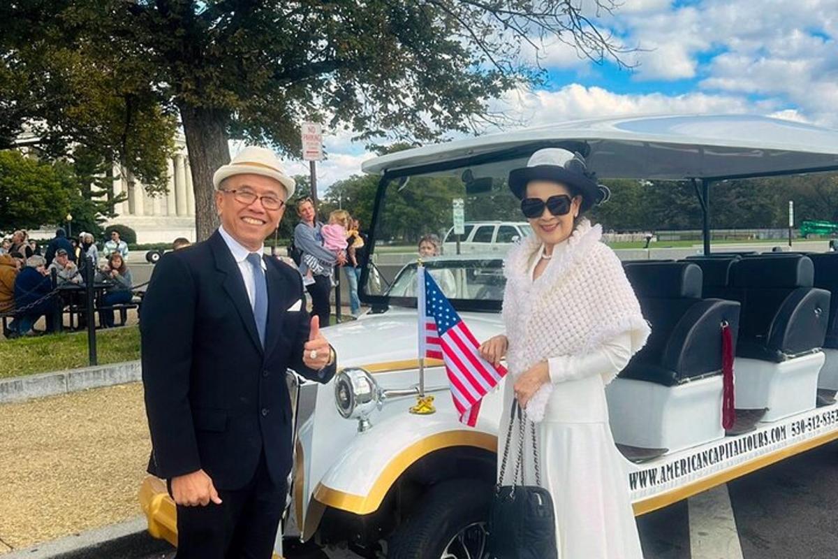 a man and a woman standing next to a car