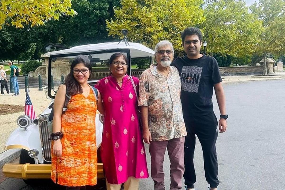 a group of people standing in front of a car