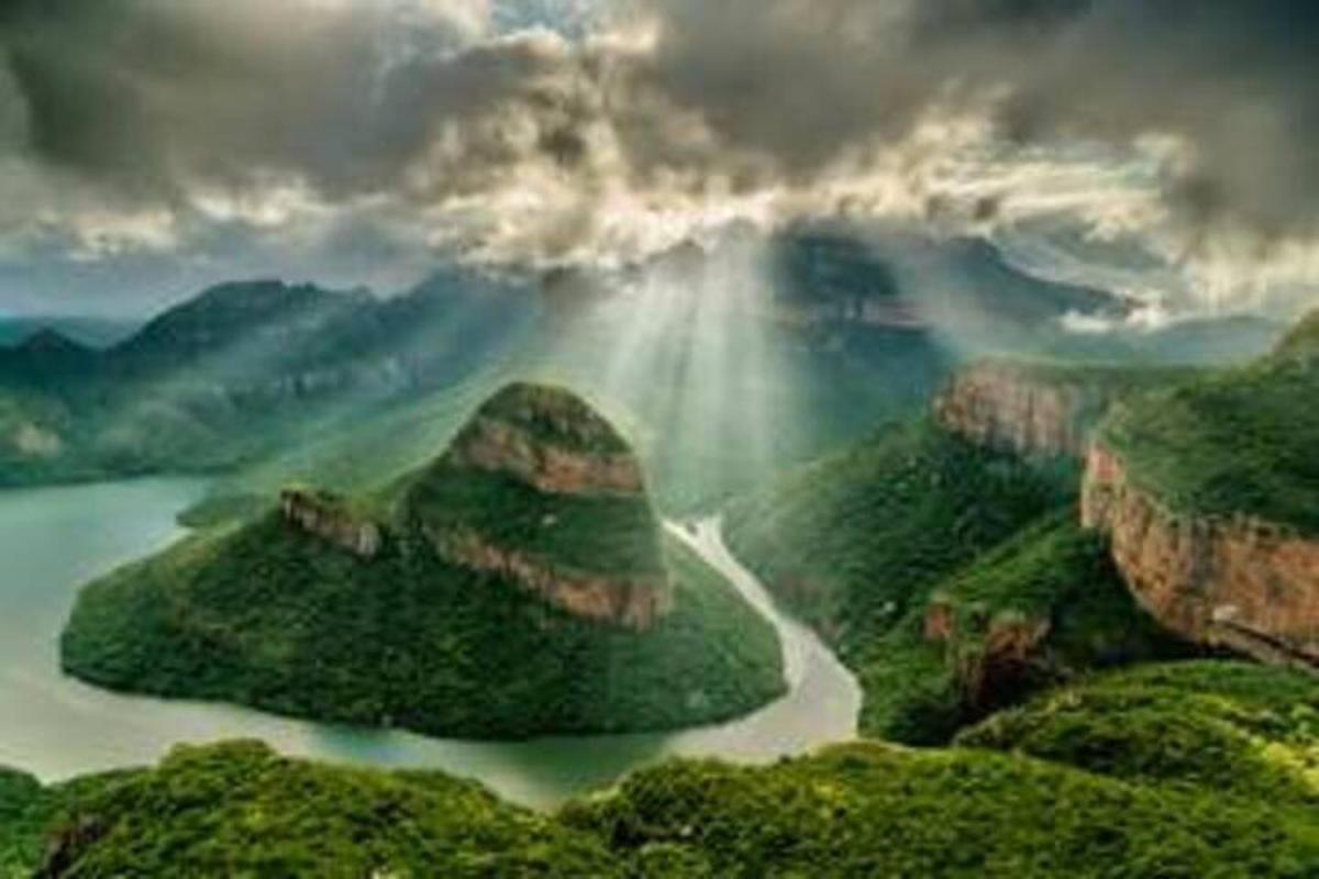 a view of a mountain range with a beam of light