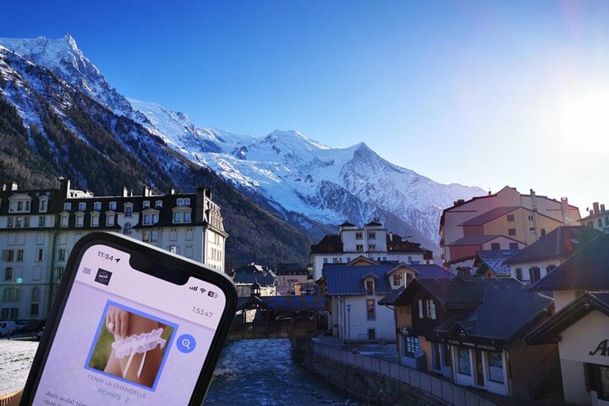 a cell phone in front of a town with mountains