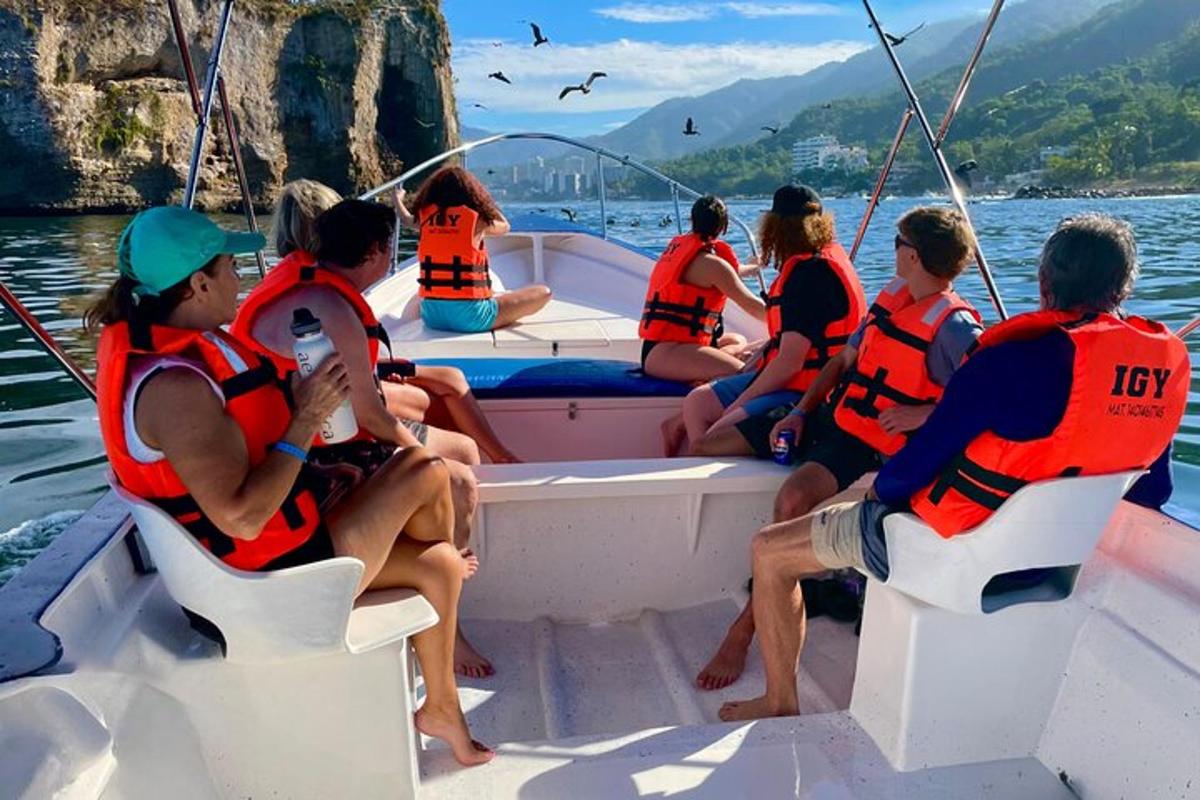 a group of people sitting on a boat in the water