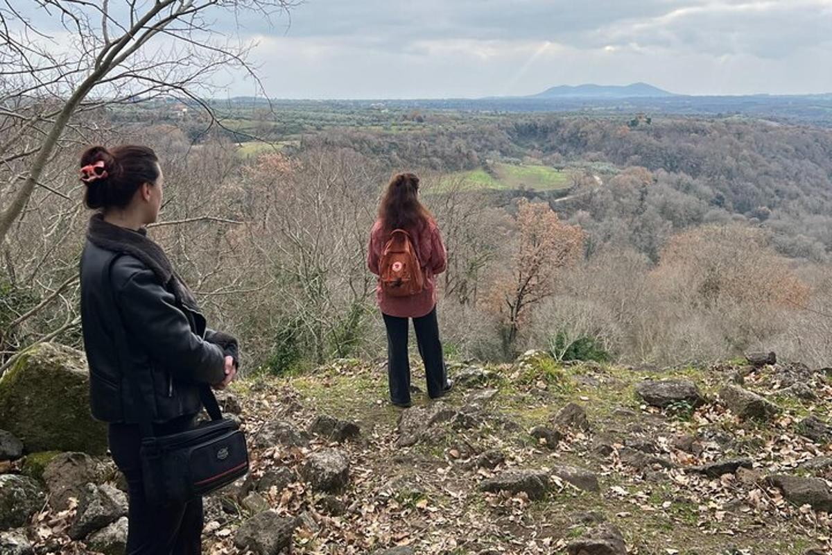 two women standing on top of a hill
