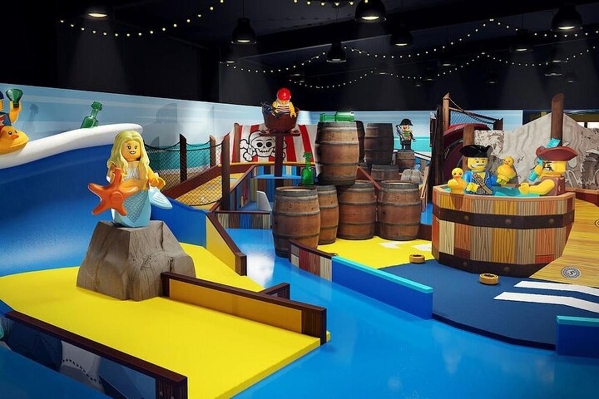 a room with a play set with toy animals and barrels