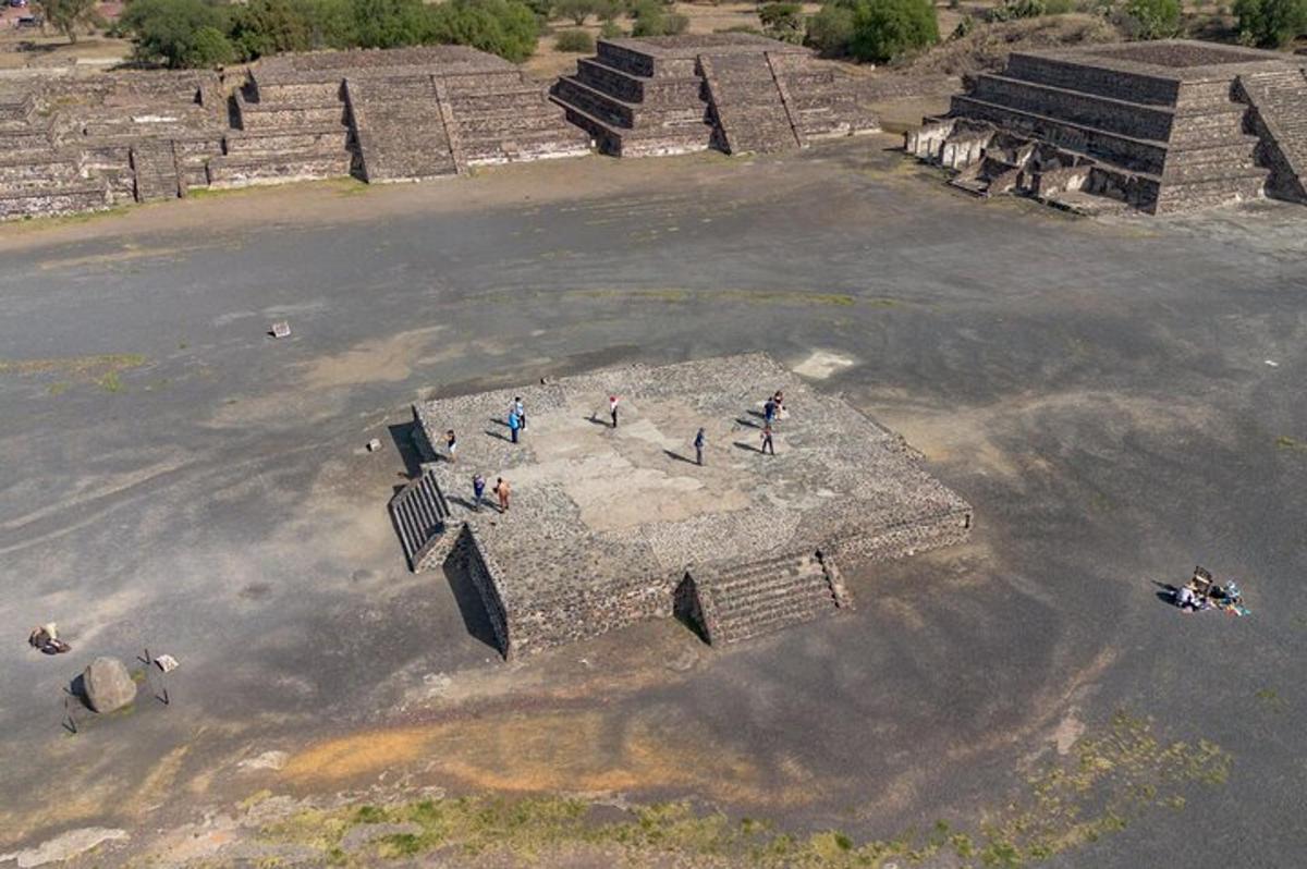 a group of people standing on top of a pyramid