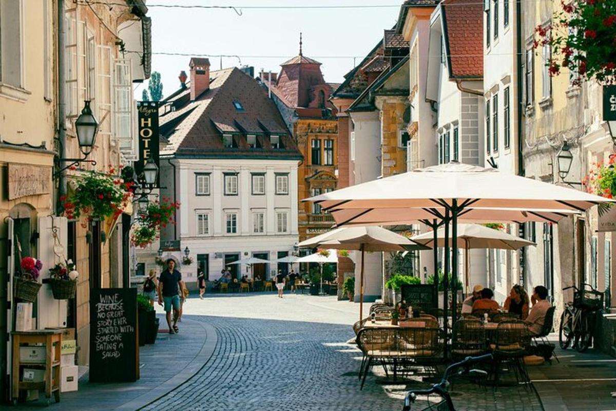 a street with tables and umbrellas in a city