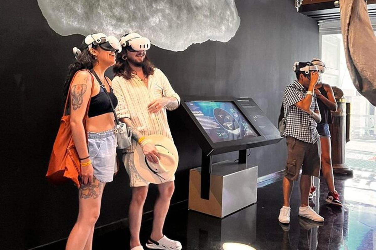 a group of people standing in a room with a tv