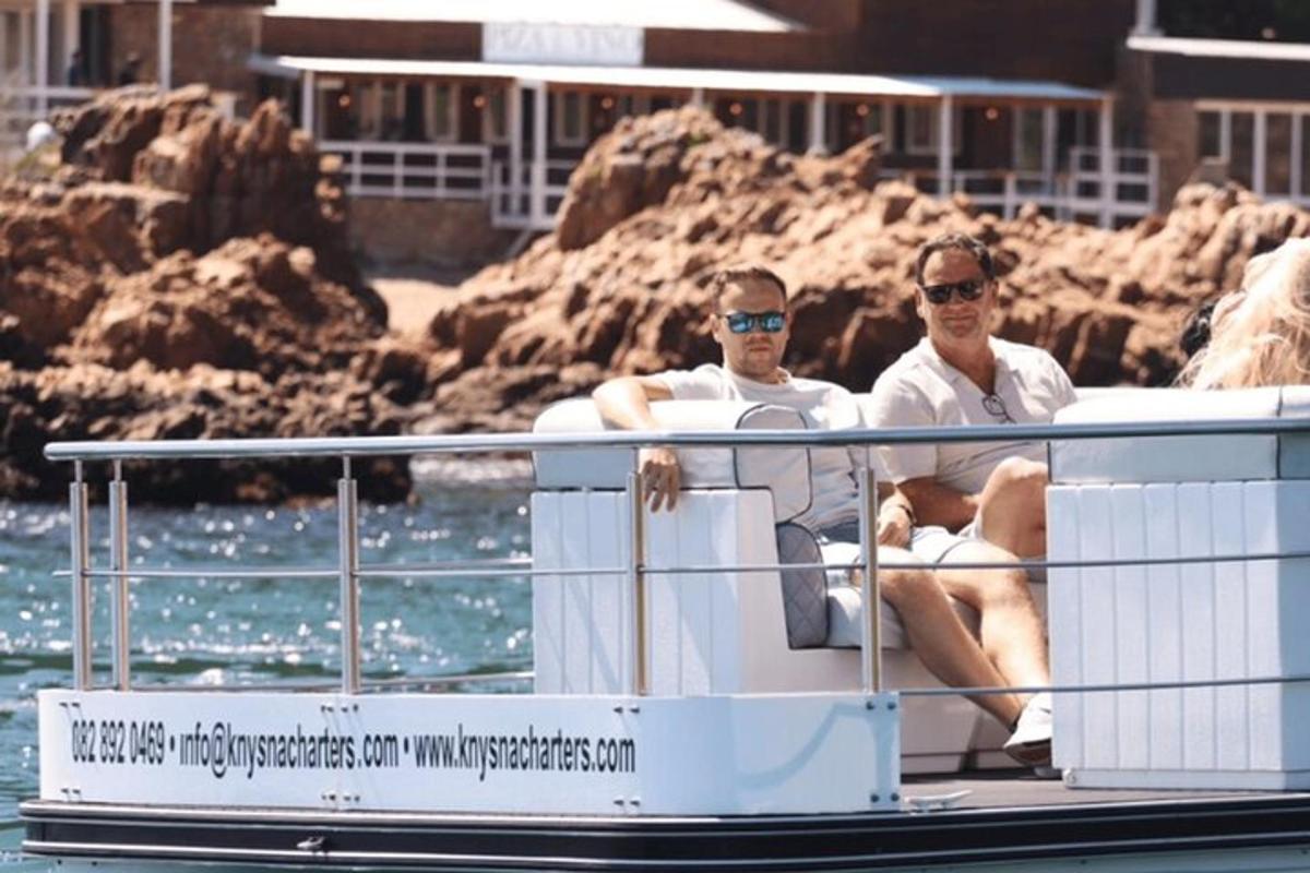 two men sitting on a boat in the water
