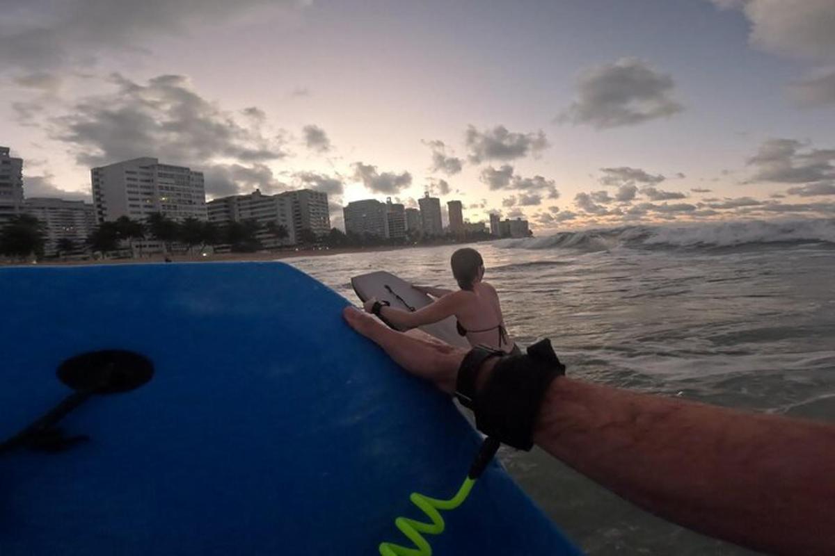 a man sitting on a surfboard in the water