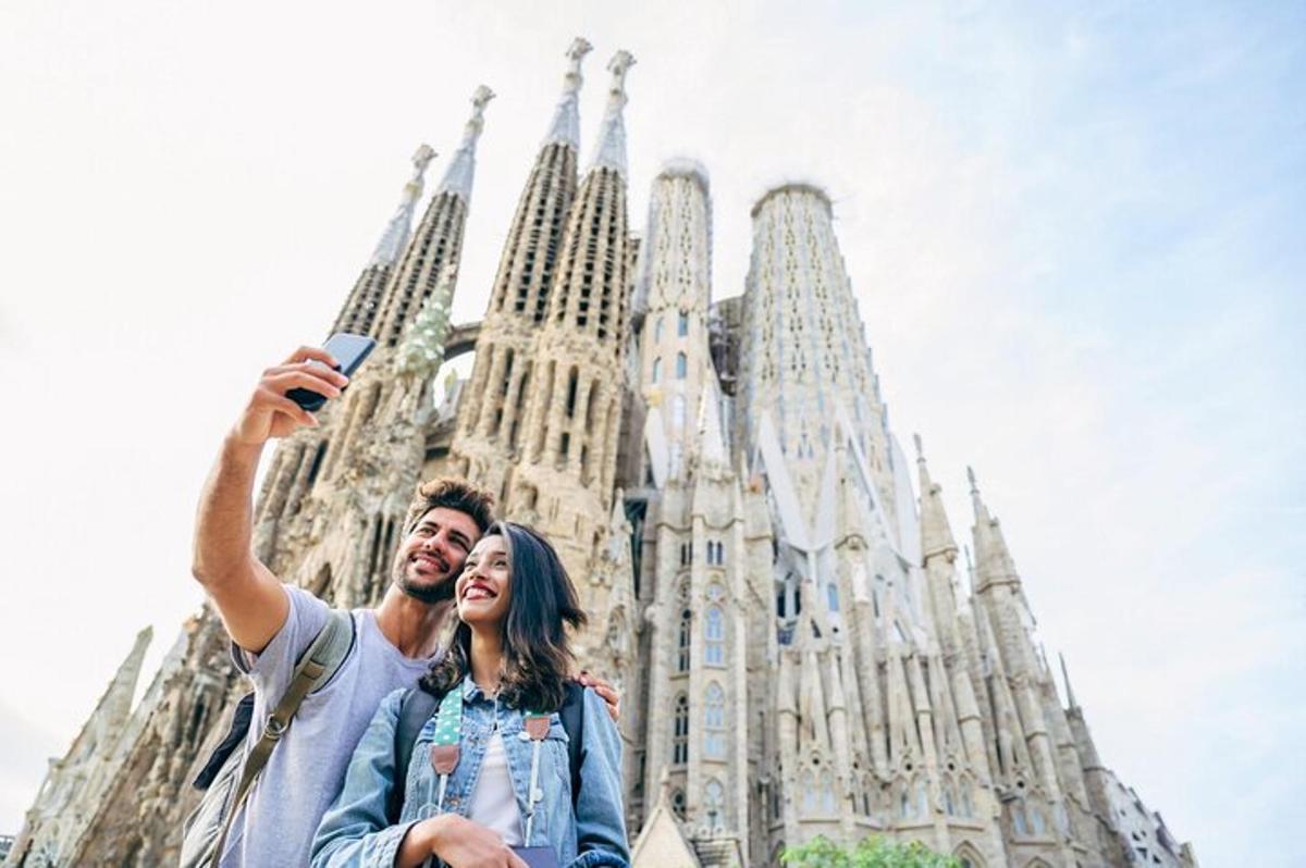 a man and woman taking a picture in front of a cathedral