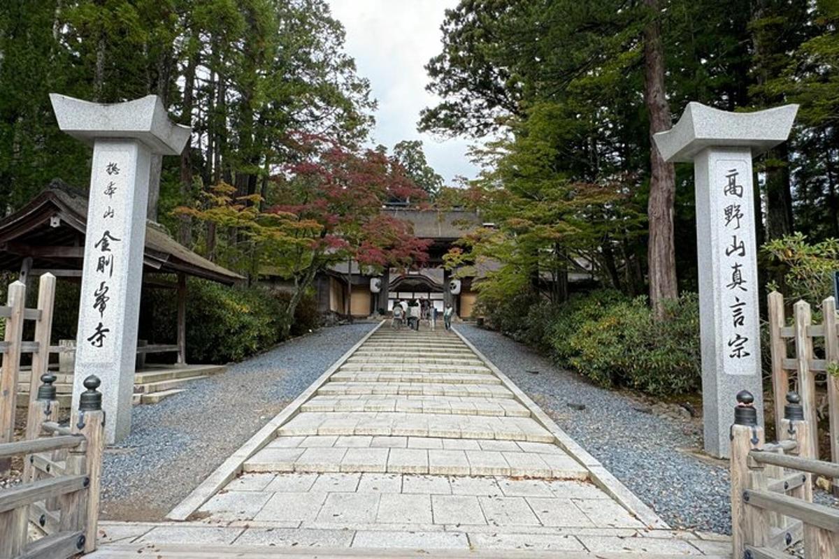 a walkway leading to a shrine with two crosses