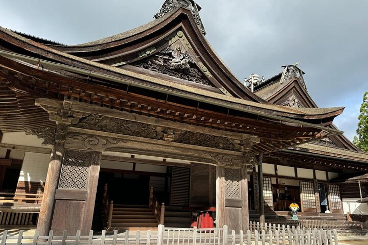 a building with a large roof with stairs in front