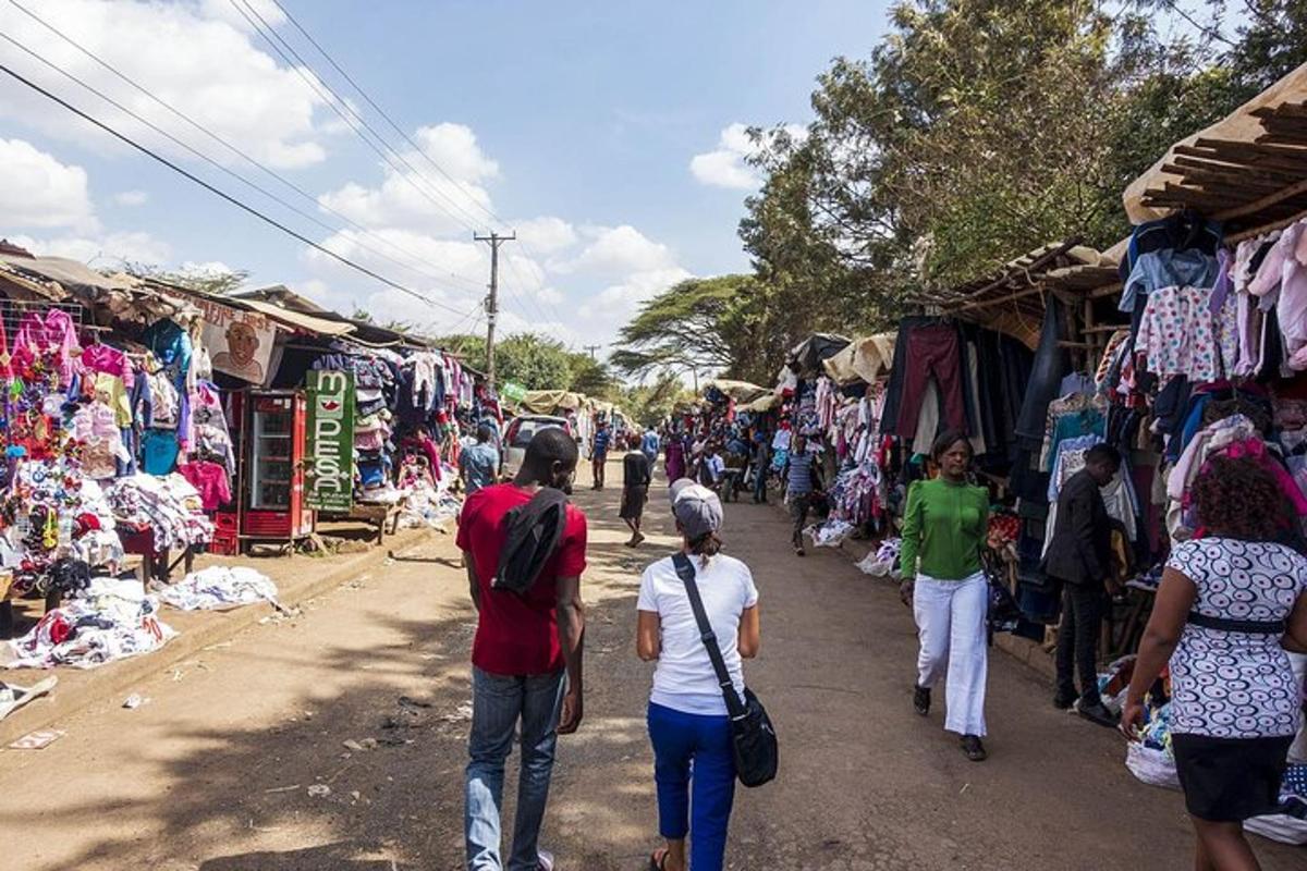a group of people walking down a street in a market