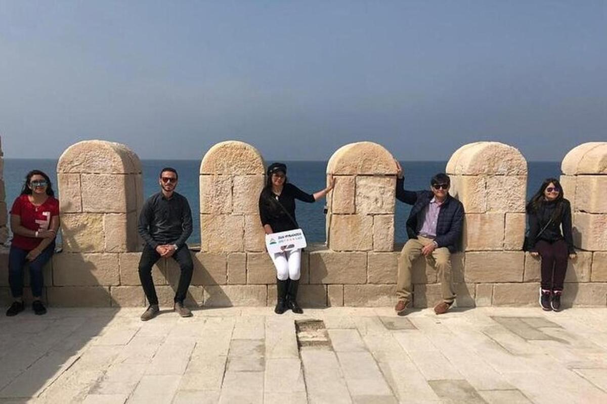 a group of people sitting on a wall