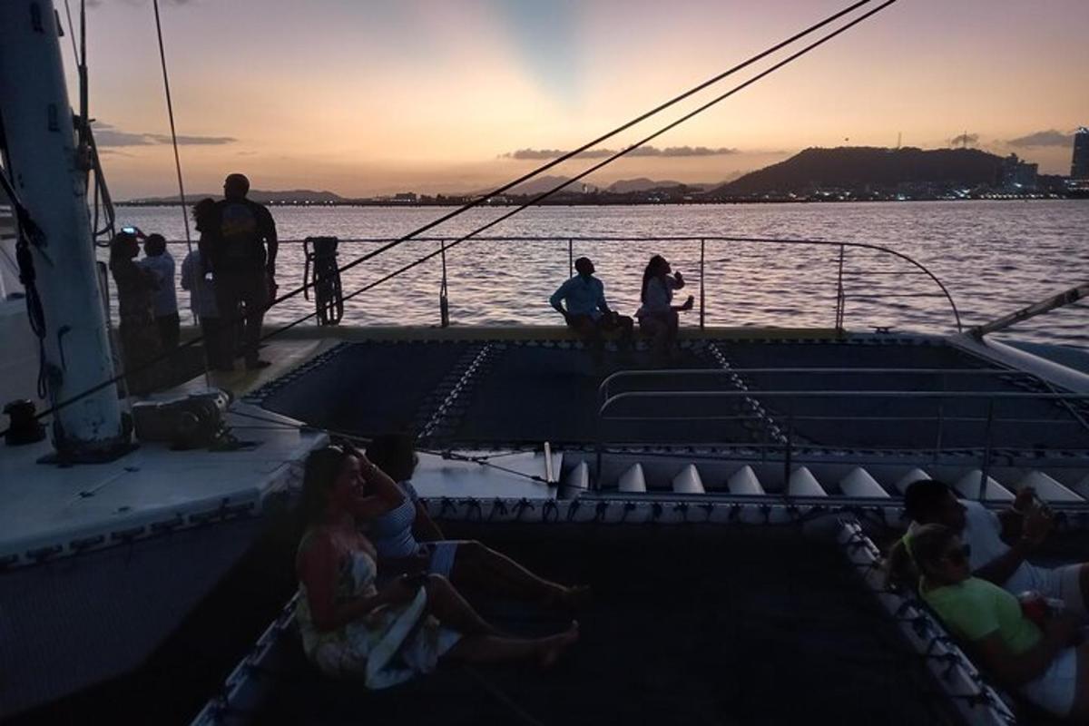 a group of people sitting on a boat in the water