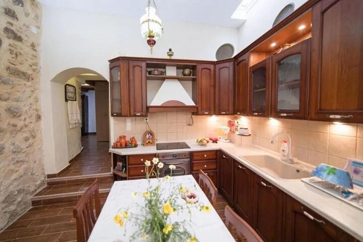a kitchen with wooden cabinets and a white counter top