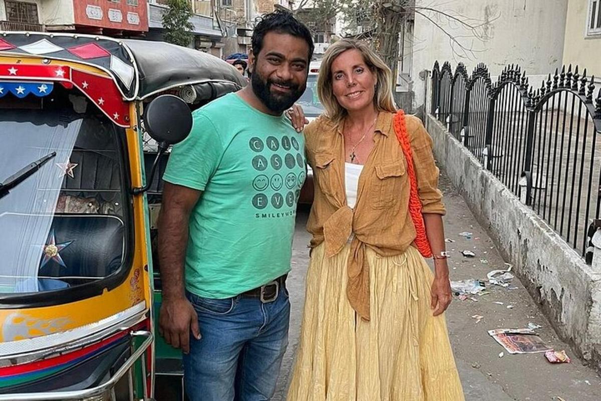a man and a woman standing next to a car