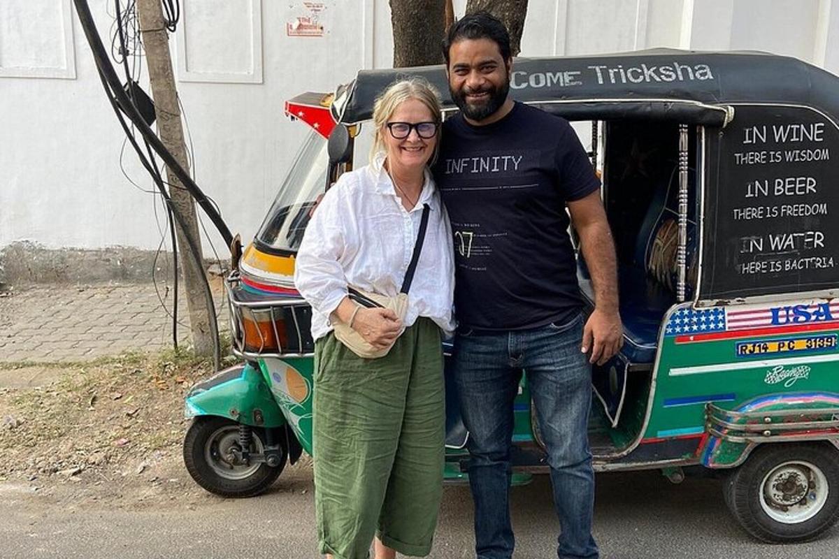 a man and a woman standing next to a motorcycle