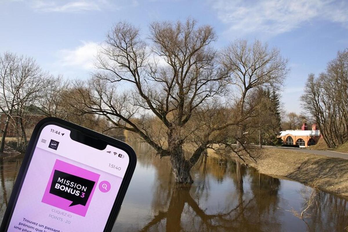 a cell phone in front of a river with a tree