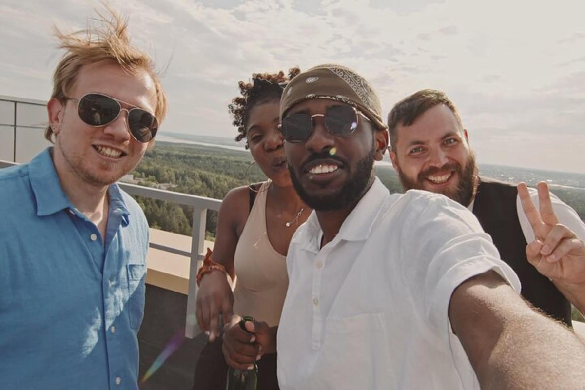 a group of people posing for a picture on a balcony