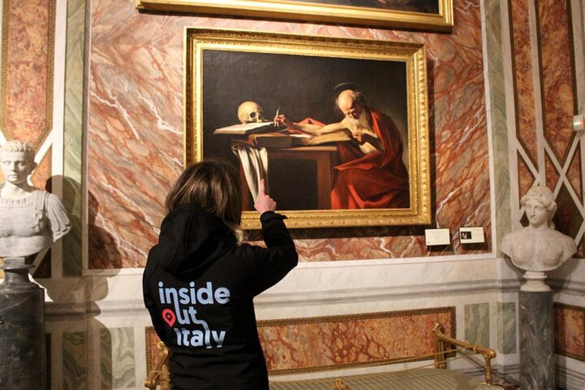 a woman taking a picture of a painting in a museum