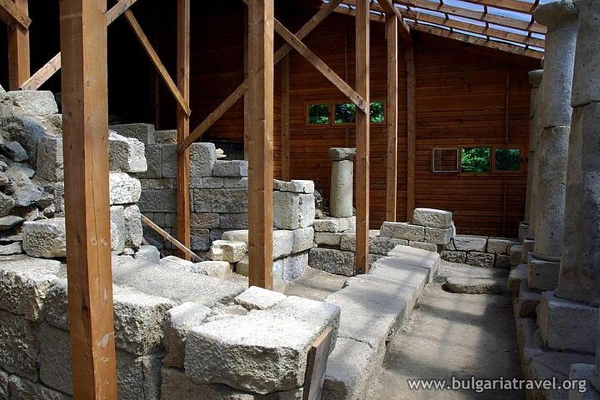 a building with a pile of stone blocks