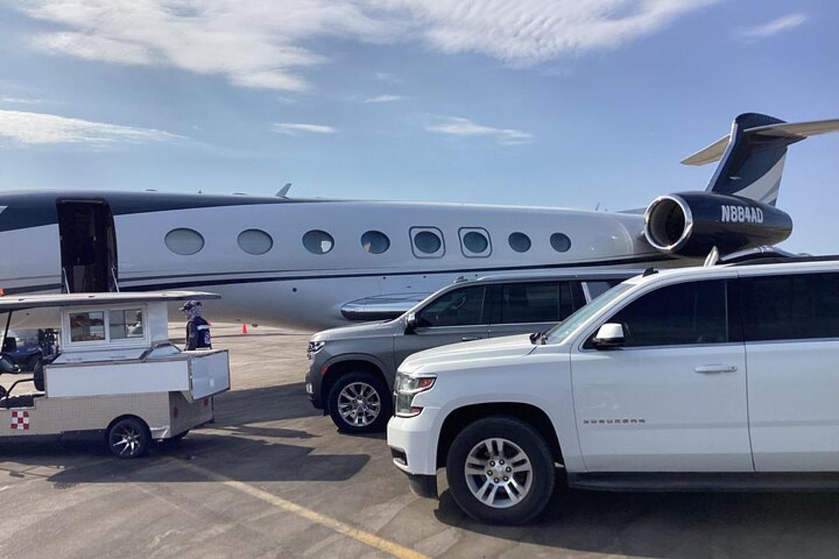 a couple of vehicles parked next to an airplane