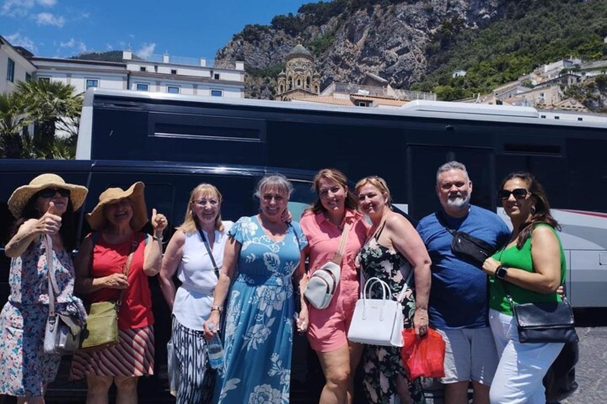a group of people standing in front of a bus