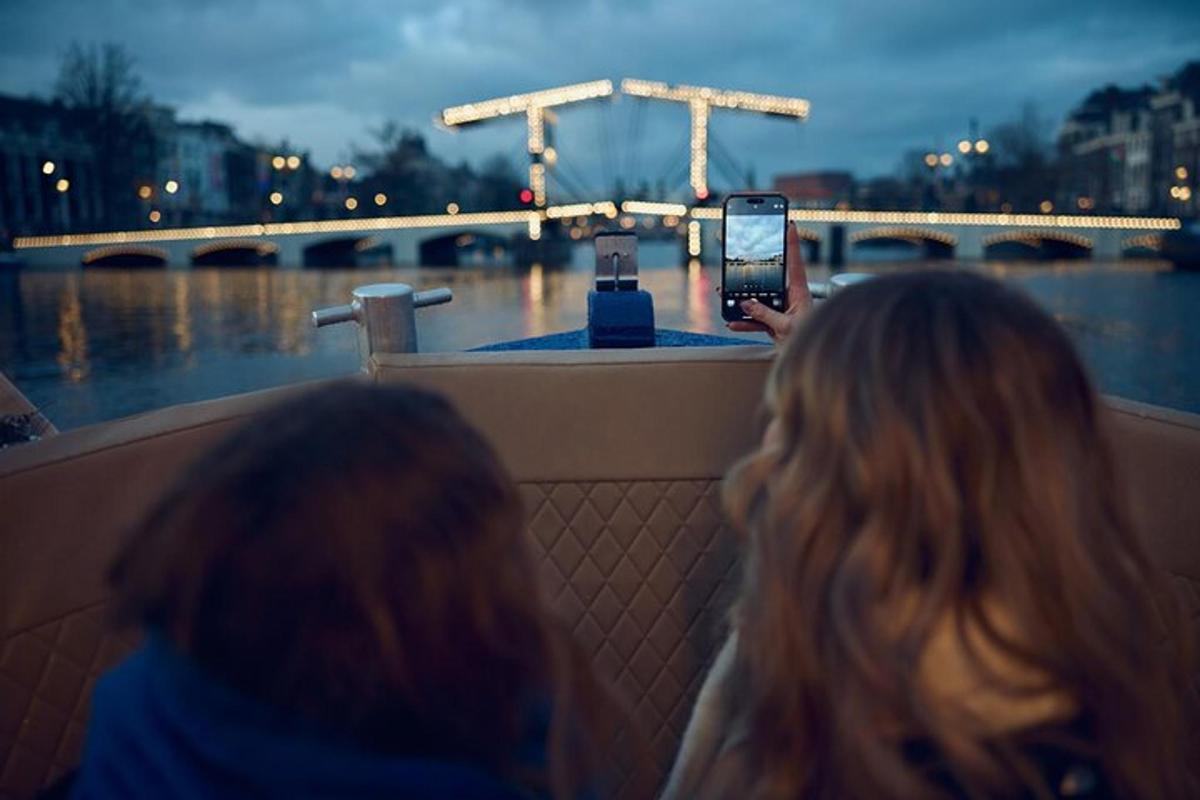 kobieta robiąca zdjęcie łodzi telefonem komórkowym