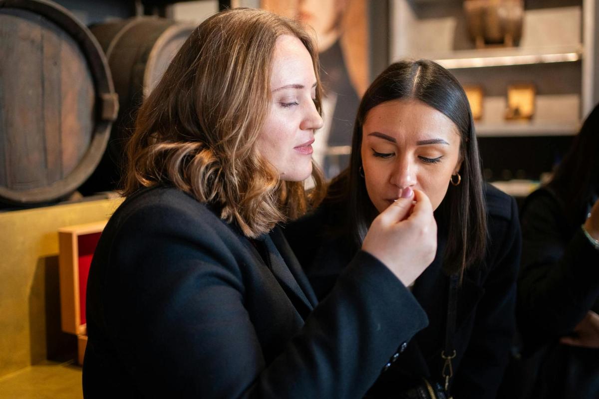 two women are sitting down and looking at something