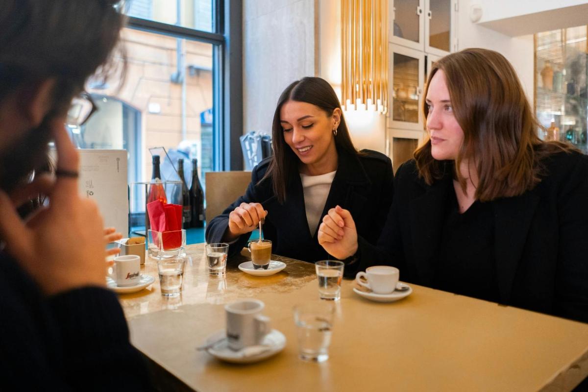 two women sitting at a table in a restaurant
