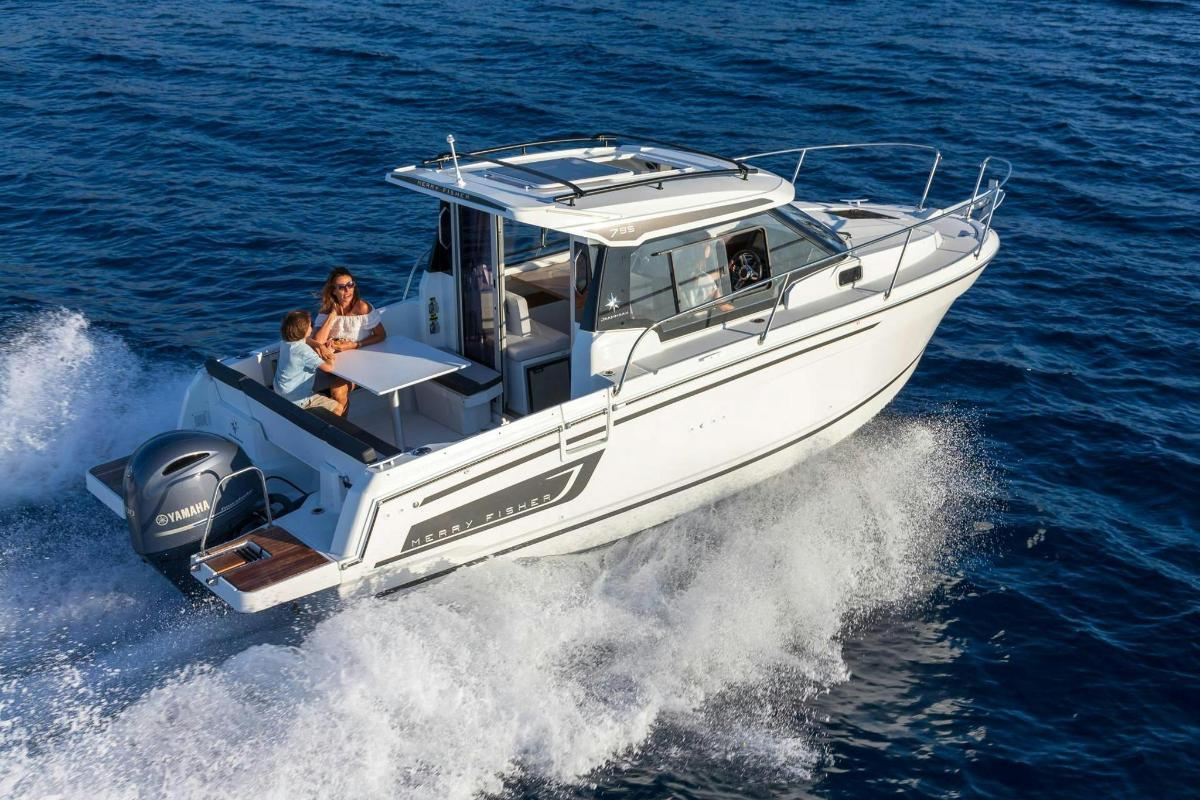a white boat in the water with two people on it